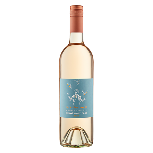Risky Business Rosé, a pale salmon pink wine with ripe strawberry notes, smooth texture, and crisp acidity.